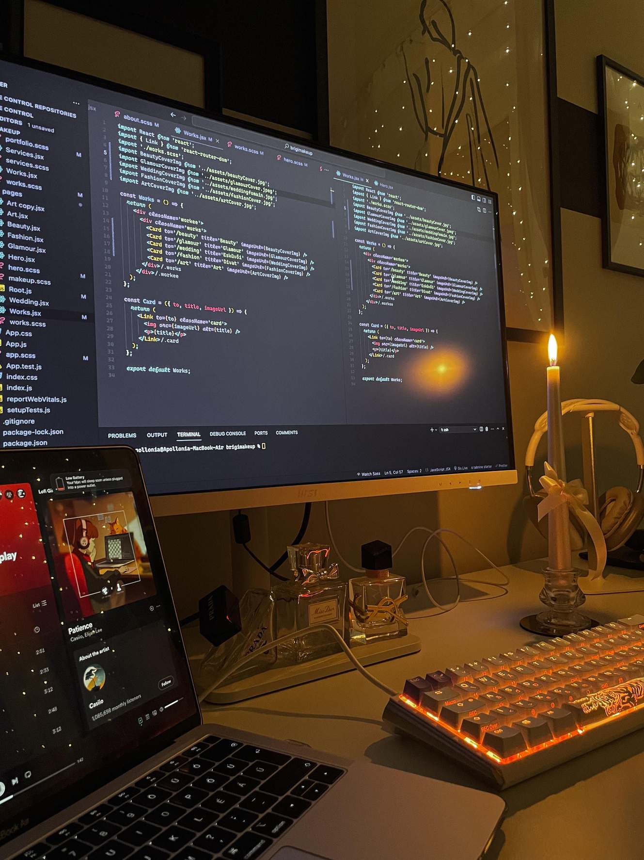 Close view of a display showing source code beside a keyboard